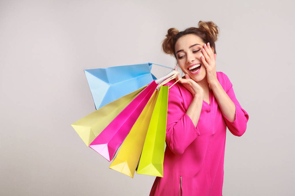 Woman posing with shopping bags and looking at camera - Fotoğraf, Görsel