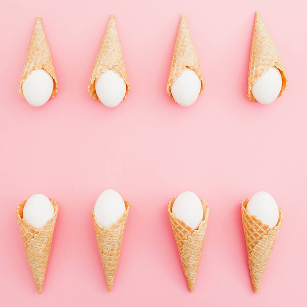Easter eggs in waffle cones on pastel pink background. Top view, Flat lay. Easter frame concept. - Photo, Image