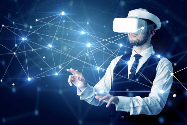 Businessman in virtual reality goggles investigate global network connectivity concept - Foto, imagen