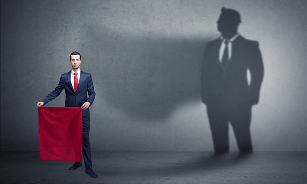 Businessman with toreador concept and his shadow on the background - Photo, Image