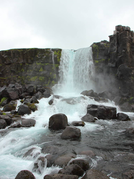 Waterfall at Thingvellir Iceland Rock Wall Cloudy Sky - Photo, Image