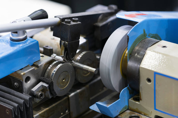 processo di lavorazione dei metalli industriali automobilistici tagliando utensile sulla rettifica CNC, processo di rettifica pin ad alta precisione
. - Foto, immagini