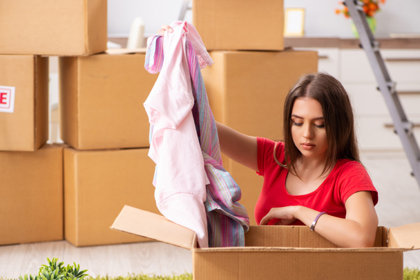 Young beautiful woman moving to new flat  - Photo, Image