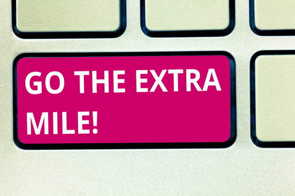 Text sign showing Go The Extra Mile. Conceptual photo Give an additional do more than is expected from you Keyboard key Intention to create computer message pressing keypad idea. - Photo, Image