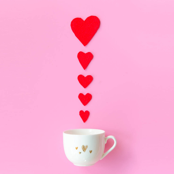 Valentines Day with red hearts row, cup coffee on pink background, copy space Valentines day Concept. Flat lay - Foto, Imagen