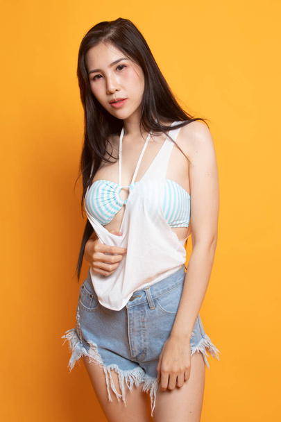 Portrait of beautiful  sexy young Asian woman on yellow background - Zdjęcie, obraz