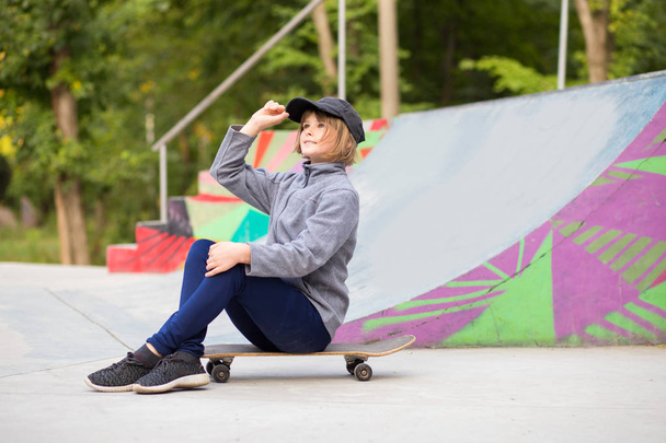 Young sporty girl riding on longboard in park. Lifestyle concept - Photo, Image