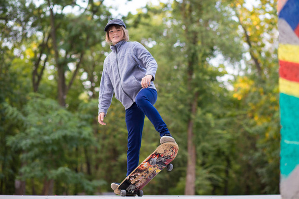 Young sporty girl riding on longboard in park. Lifestyle concept - Photo, Image