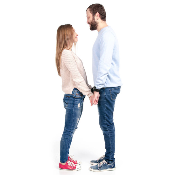 Beautiful woman and man hold hands against - Photo, image