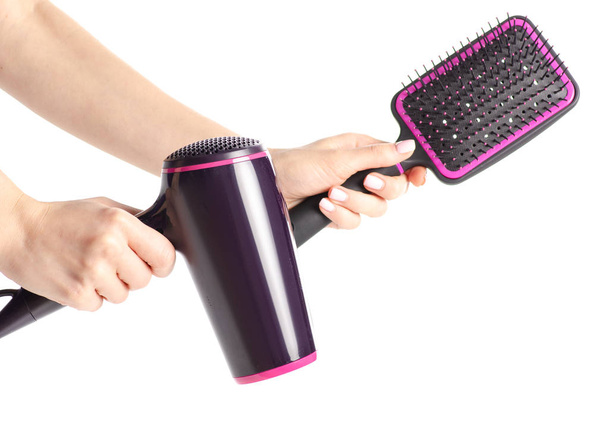 Hair dryer and hairbrush in hand - Zdjęcie, obraz