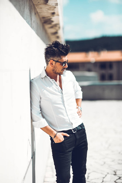 Portrait of a successful young businessman dressed leaning to wall . Concept Fashionable Young Man - Fotoğraf, Görsel