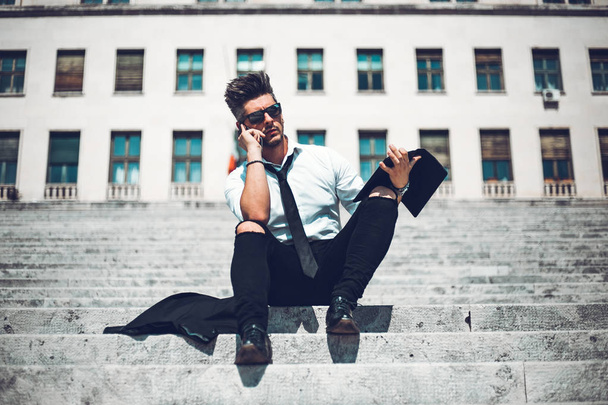 Depressed unsuccessful businessman feels terrible headache, hands shocked by bankruptcy stock downfall sitting on stone stairs. Stressed tired man feels despair lost money online or got problem debt. - Fotoğraf, Görsel