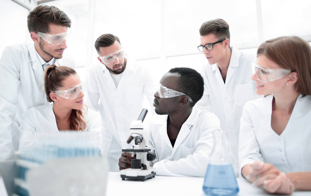 Focused and serious female and male chemists in lab coats and sa - Fotó, kép