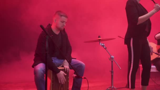 Ντράμερ στο συγκρότημα μουσική εκτέλεση του μέρος της ένα τραγούδι στη σκηνή κατά τη διάρκεια του show με κόκκινο φως και τον καπνό στο παρασκήνιο. - Πλάνα, βίντεο