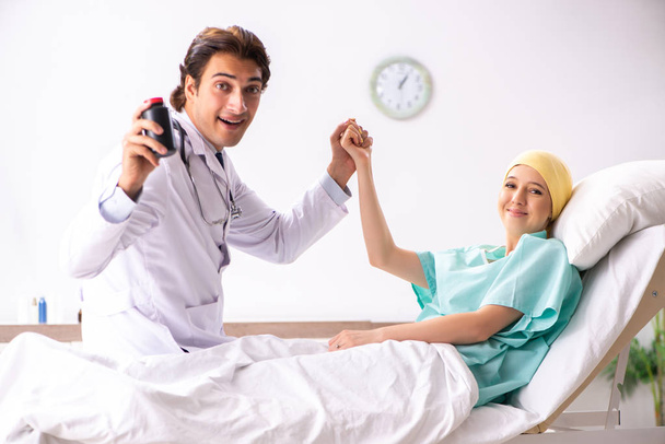Young handsome doctor visiting female oncology patient  - Photo, Image