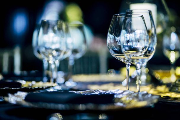 Luxury table settings for fine dining with and glassware, beautiful blurred  background. Preparation for holiday  Christmas and Hannukah dinner night. - Foto, immagini