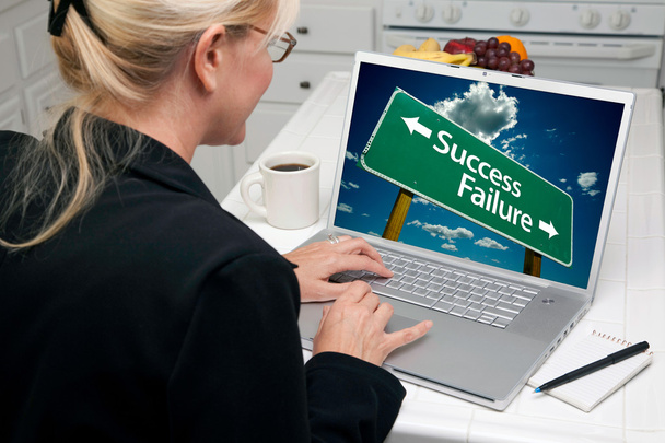Woman In Kitchen Using Laptop with Success or Failure on Screen - Photo, Image
