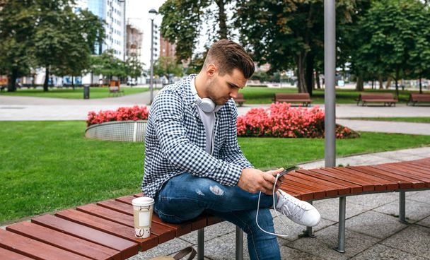 Young man using tablet outdoors - Photo, Image