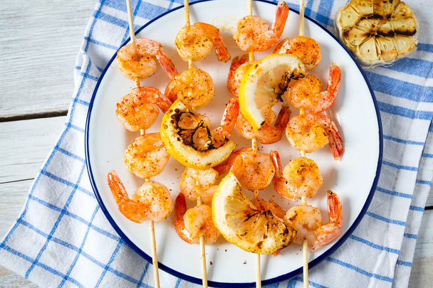 grilled shrimp skewers on wooden surface - Photo, Image