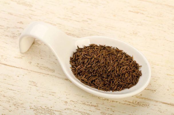 Caraway pile in the bowl over wooden background - Photo, Image