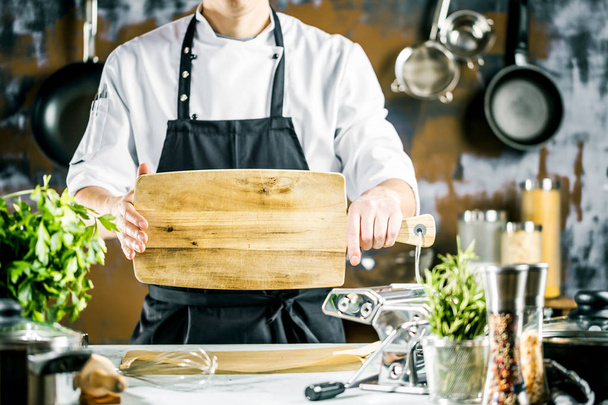 Cooking, profession and people concept - male chef cook making food at restaurant kitchen - 写真・画像