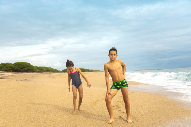 Kids playing on the beach. Active and  healthy childhood. Careless childhood. - Foto, immagini