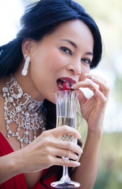 Woman enjoying champagne and strawberries - Fotó, kép