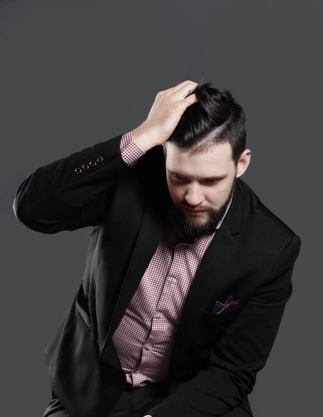 businessman adjusting his hair.isolated on grey background - Foto, Bild