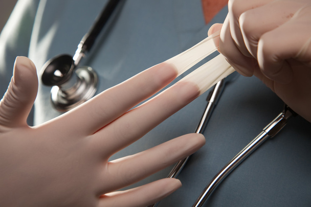 Doctor Removing Surgical Gloves - Photo, Image