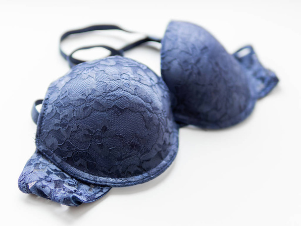 Blue lace bra on white background. Elegant underwear. - 写真・画像