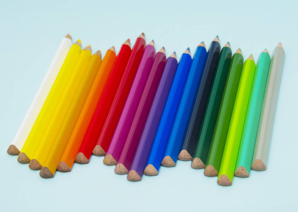 colorful pencils on blue paper - Foto, Bild