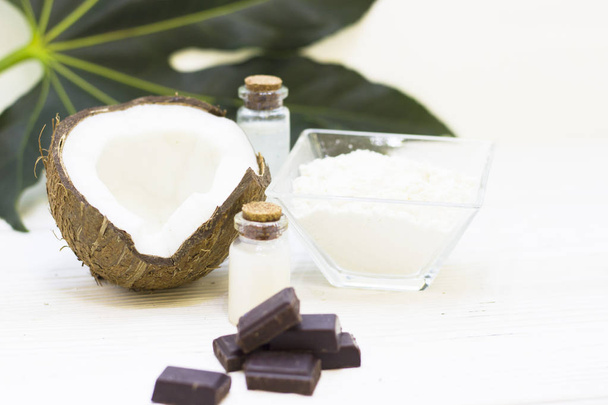 Natural herbal skin care products, top view ingredients coconut, chocalate on table concept of the best all natural face moisturizer. Facial treatment preparation background - Photo, image