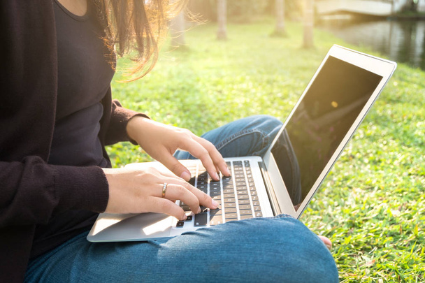 young asian girl using laptop at a outdoors - Foto, afbeelding