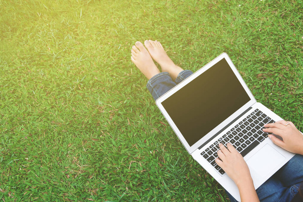 woman using blank screen laptop at a outdoors - Photo, Image