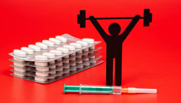 pictograma de levantamiento de pesas con pastillas y cinta métrica, fondo rojo
 - Foto, imagen