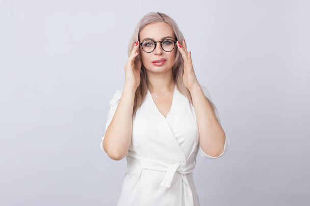 Image of beautiful business woman standing over white background wearing glasses - Foto, Imagem