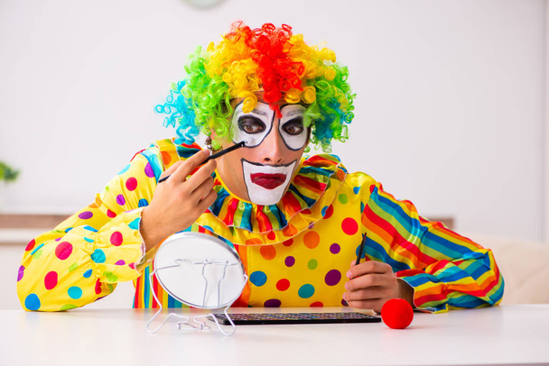 Male clown preparing for perfomance at home  - Photo, Image