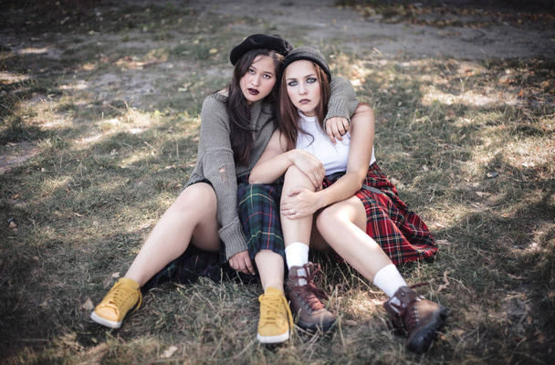 Two girls spend time together outdoors. The concept of difficult teenagers, bad students. Teenage problems. - Photo, Image