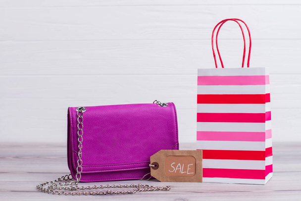 Female pink bag on wooden background. - Φωτογραφία, εικόνα