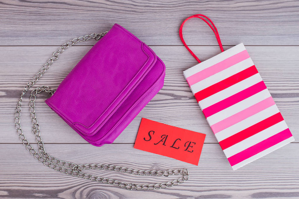 Pink female handbag on wooden background. - Photo, Image