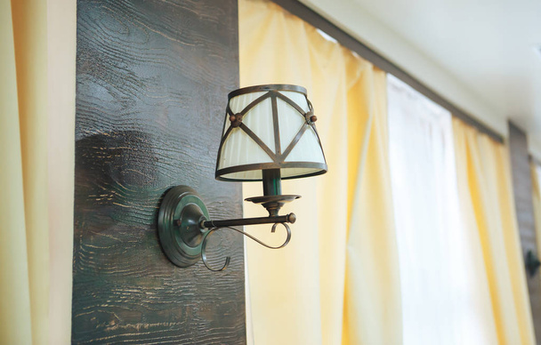 vintage wall lamp. The lamp on the wooden wall in the background window - 写真・画像