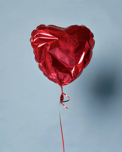 Party is over deflated red heart balloon object for birthday party or love valentines day - Foto, Imagen