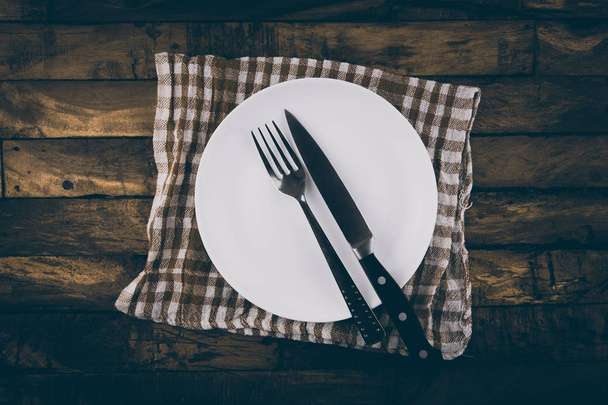 Top view of empty white food plate with fork and knife - Photo, image