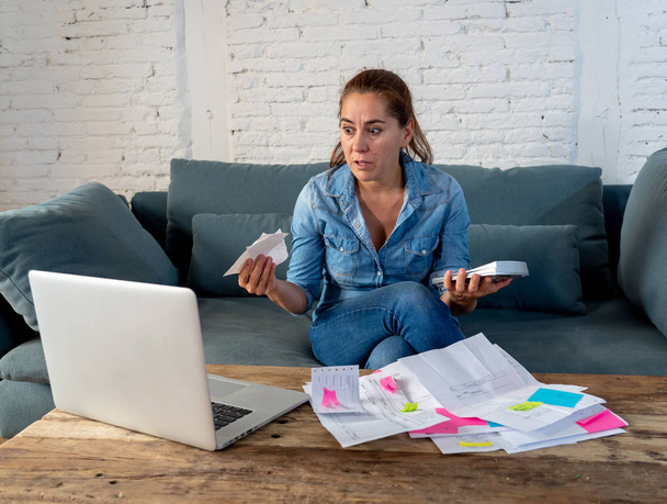 Portrait of young single mother business woman feeling stressed accounting finances with laptop and calculator in living room in Paying off debts and Domestic bills and financial problems concept. - Photo, Image