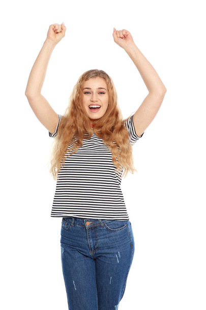 Happy young woman celebrating victory on white background - Фото, изображение