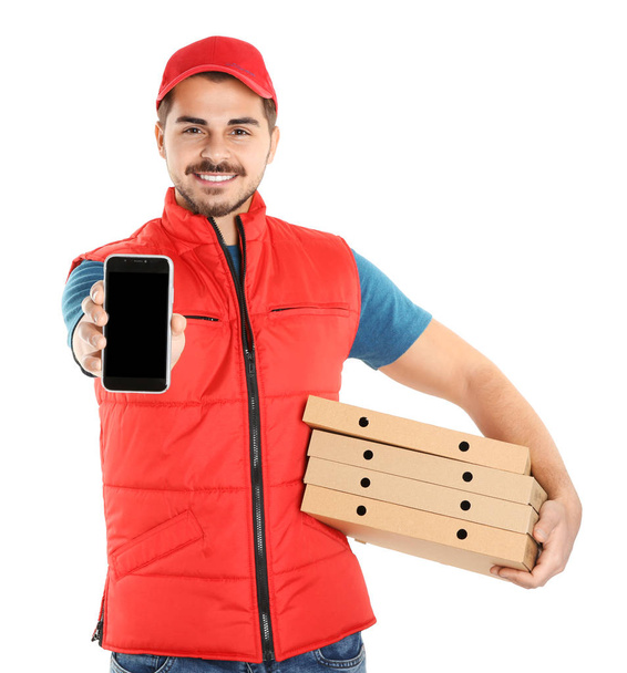 Young man holding pizza boxes and smartphone isolated on white, mockup for design. Online food delivery - 写真・画像