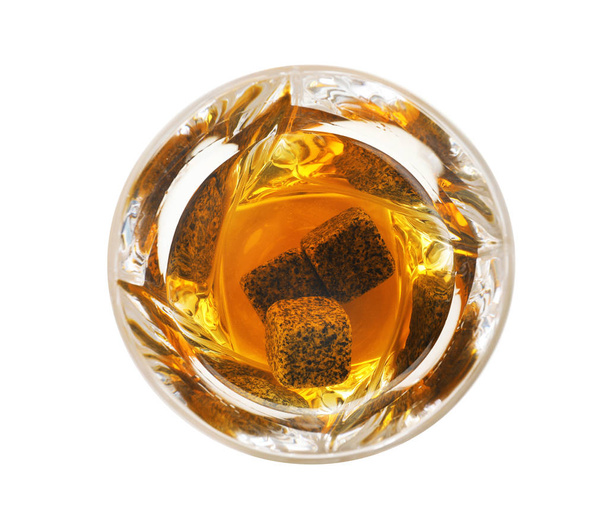 Glass of expensive whiskey with stones on white background, top view - Fotó, kép