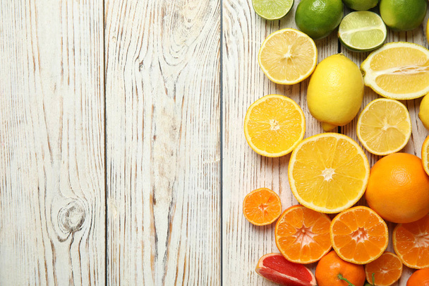 Different citrus fruits on wooden background, top view. Space for text - Fotoğraf, Görsel