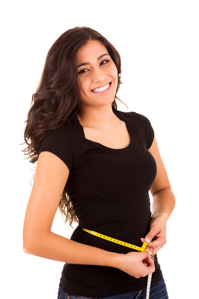 Beautiful slim woman measuring her body with a measuring tape - Φωτογραφία, εικόνα
