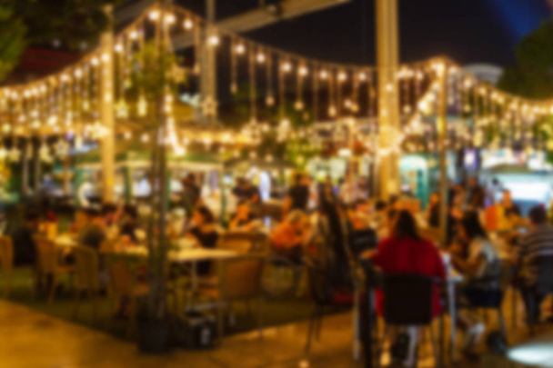 abstract blur image of night festival in a restaurant and The atmosphere is happy and relaxing with bokeh for background - Foto, Bild